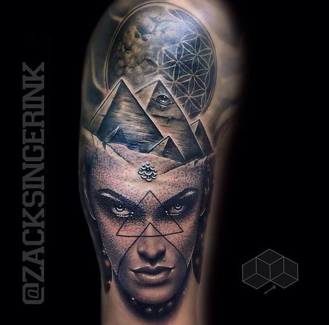 Engraving style black ink shoulder tattoo of woman portrait stylized with pyramids and planet