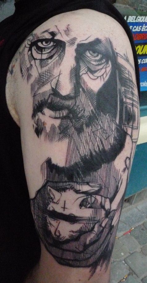 Engraving style black ink shoulder tattoo of old man face with rat