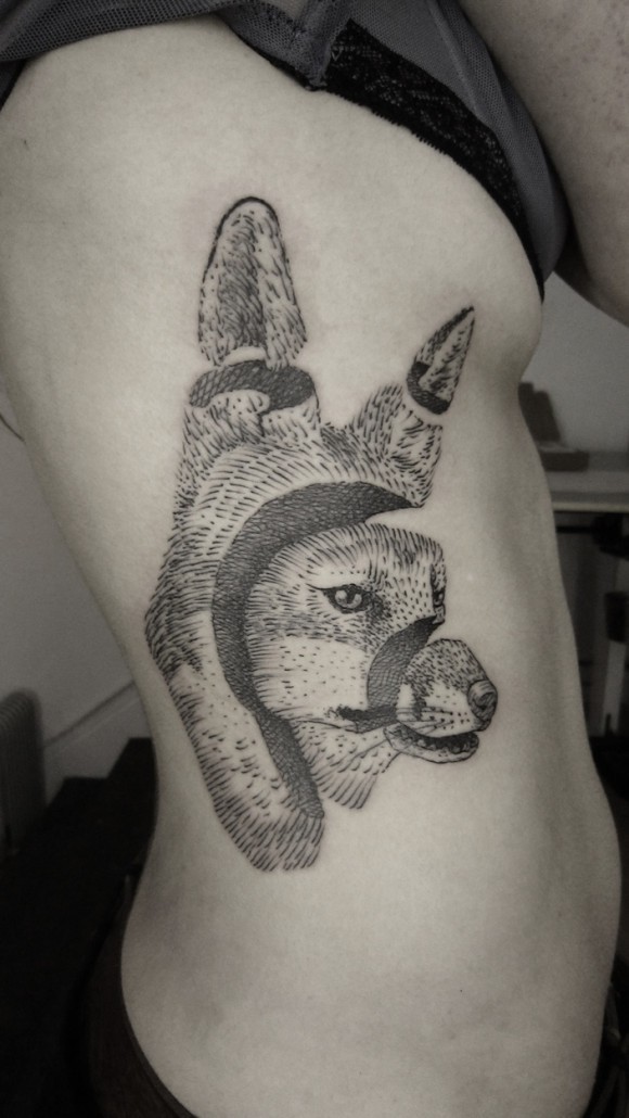 Engraving style black ink side tattoo of divided fox