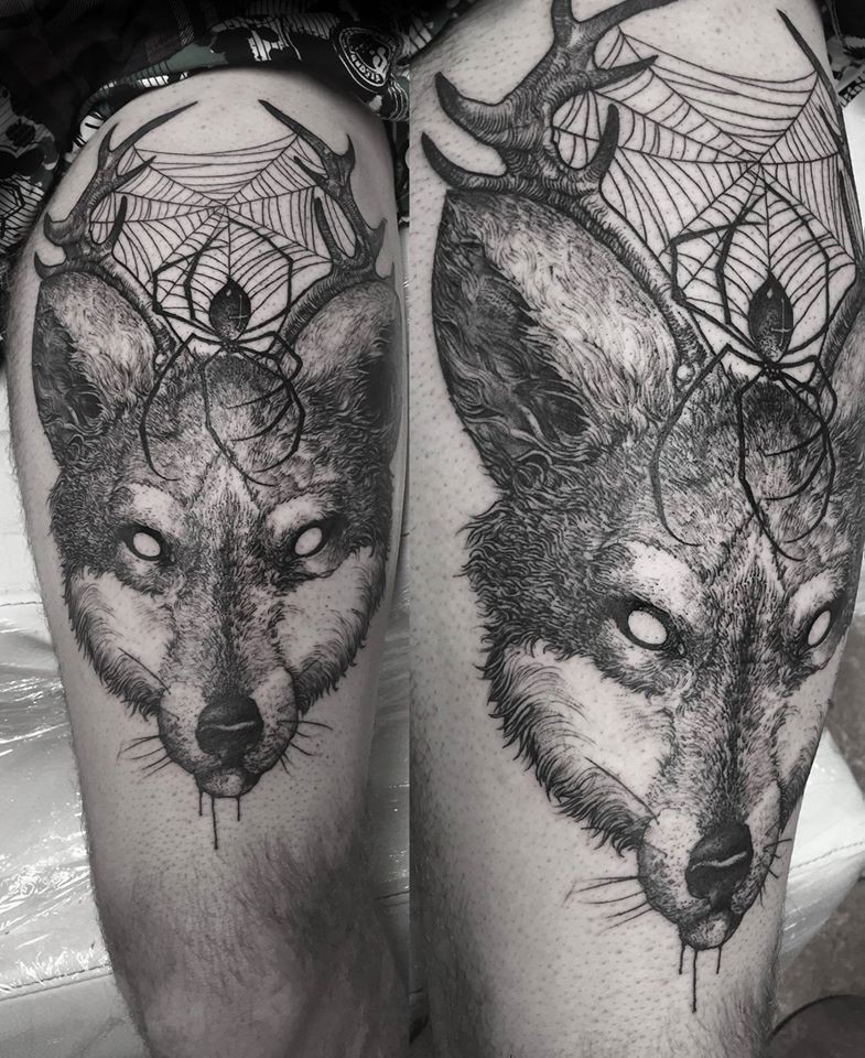 Engraving style black ink thigh tattoo of fox head with spire and horns