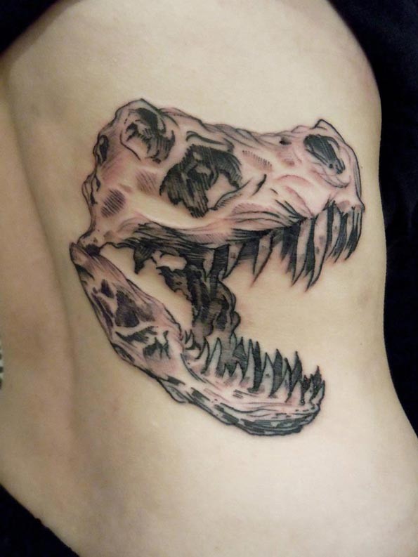 Engraving style black ink thigh tattoo of dinosaur skull