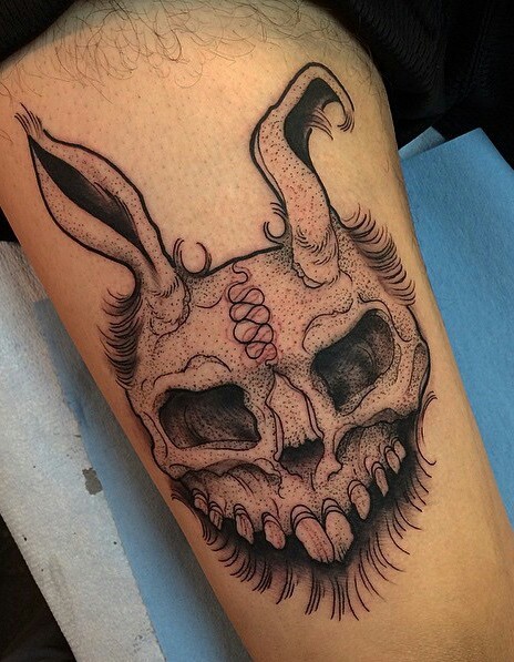 Engraving style black ink thigh tattoo of evil rabbit skull