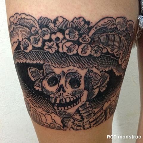 Engraving style black ink thigh tattoo of woman skeleton with hat
