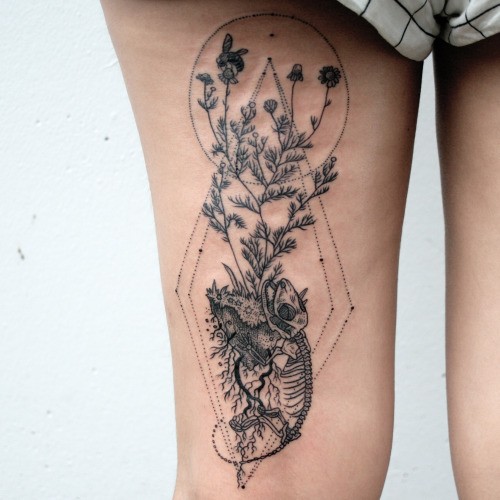 Engraving style black ink thigh tattoo of lizard skeleton with plants