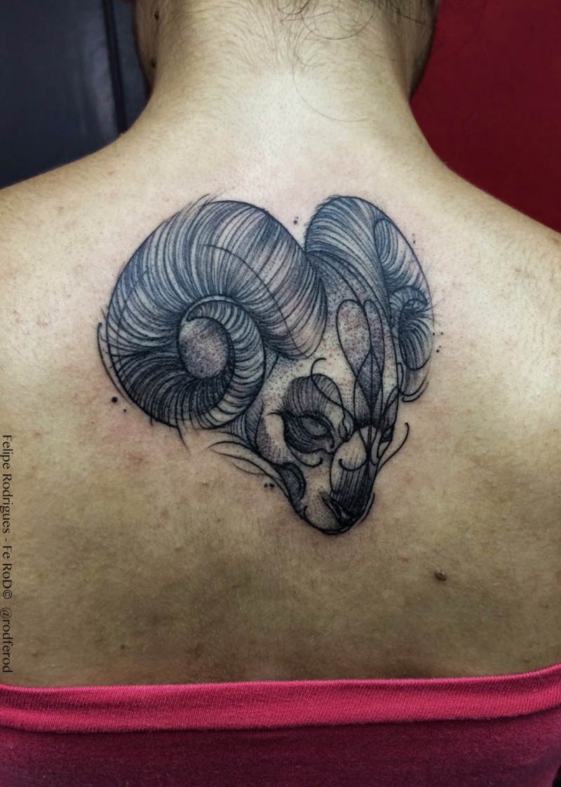 Engraving style black ink upper back tattoo of small goat head with heart