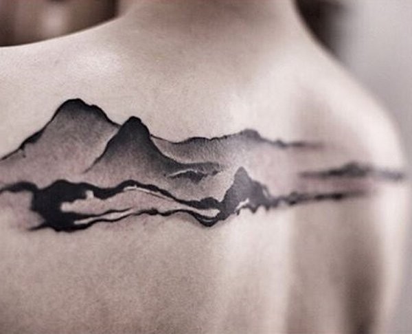 Engraving style black ink upper back tattoo of mountains