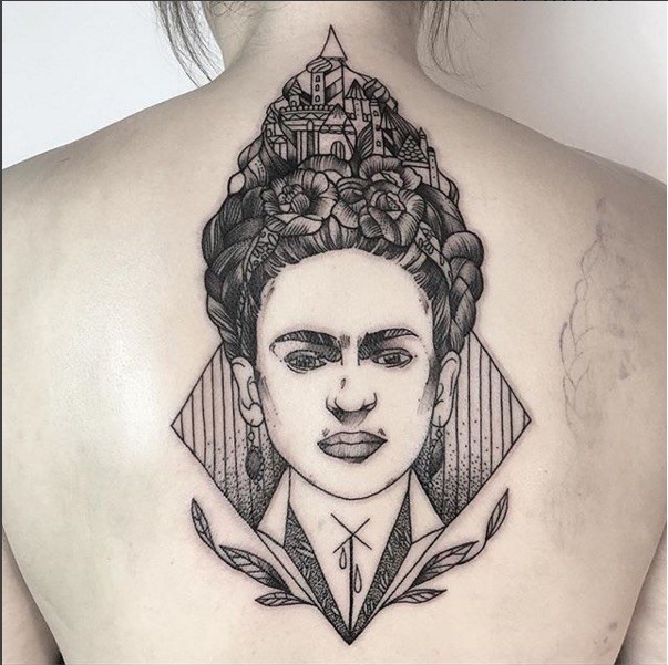 Engraving style black ink upper back tattoo of interesting looking woman with castle on hair
