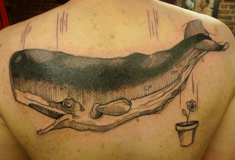 Engraving style black ink upper back tattoo of large whale with small flower in pot