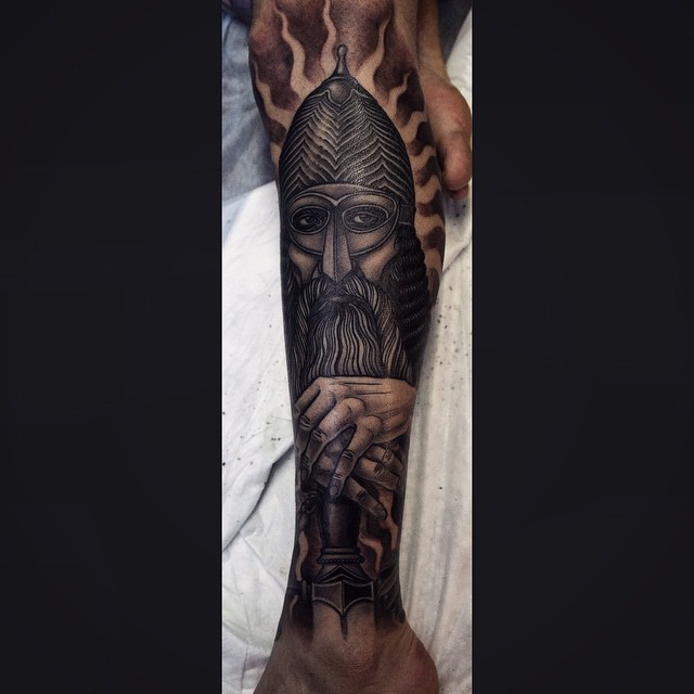 Engraving style colored leg tattoo of medieval warrior with beard