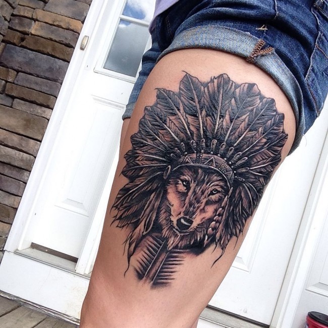 Engraving style colored thigh tattoo of Indian wolf in feather helmet