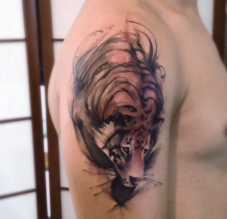 Engraving style colored tiger tattoo on shoulder