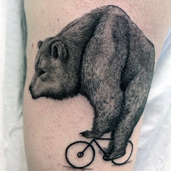 Enormous sized black ink bear on tiny bicycle arm tattoo
