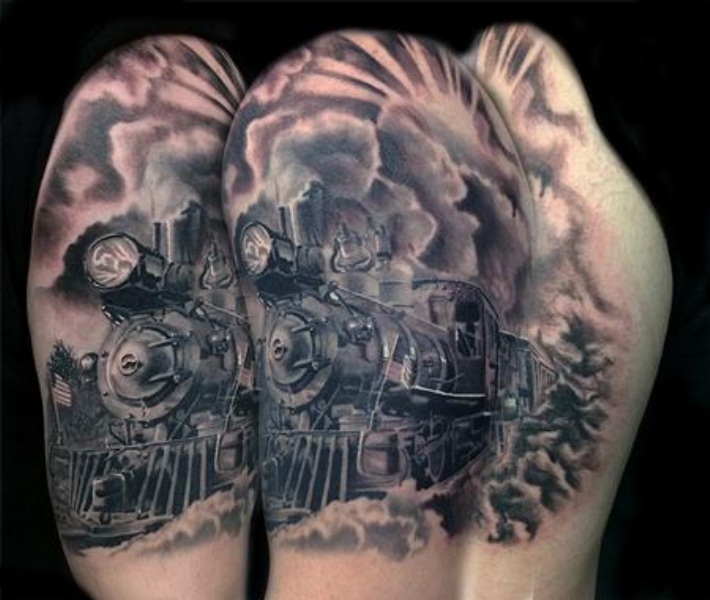 Enormous very detailed upper arm tattoo of train with clouds of steam