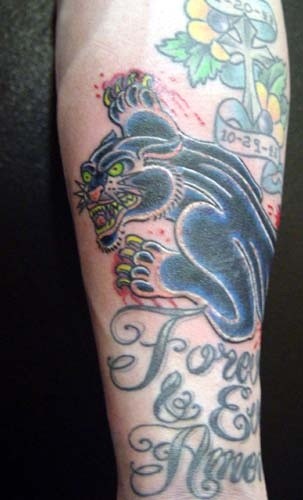 Evil black panther tattoo on arm