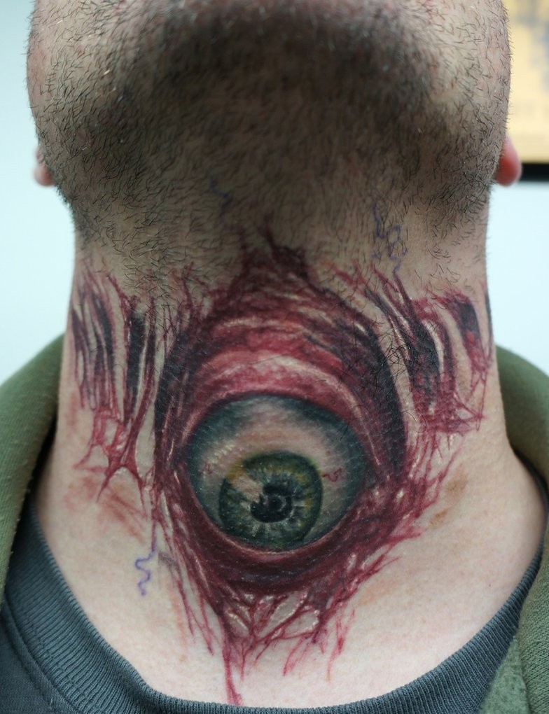 Evil eyeball tattoo on throat healed by graynd