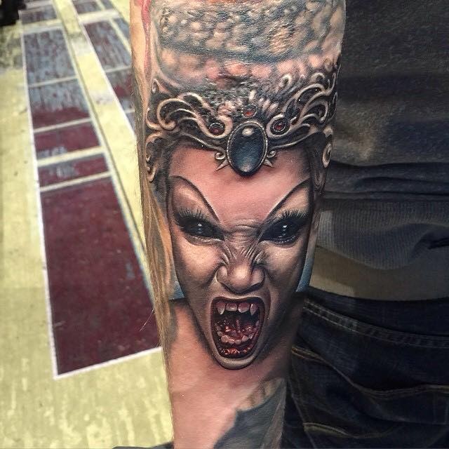 Evil vampiress with diadem forearm tattoo