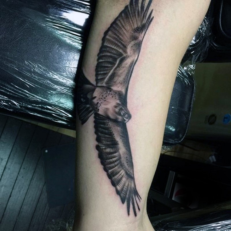Excellent detailed black ink arm tattoo of flying eagle