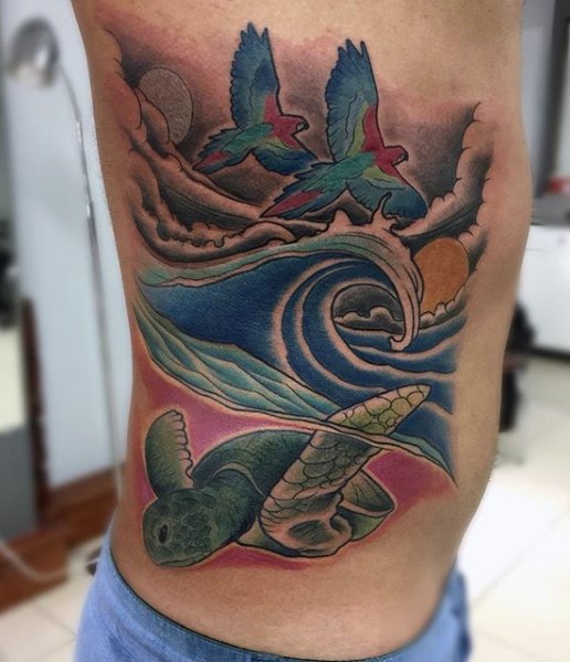 Fabulous pained and colored flying birds with turtle and ocean tattoo on side