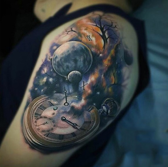 Fantastic combined old clock with space colored tattoo on upper arm