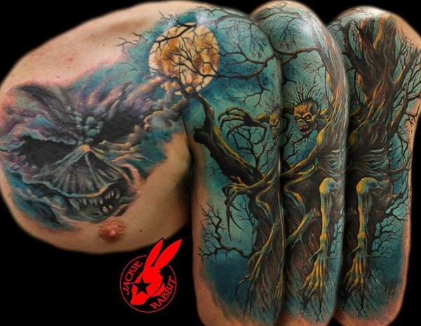 Fantastic looking colored horror style monster zombie sitting on shoulder tattoo