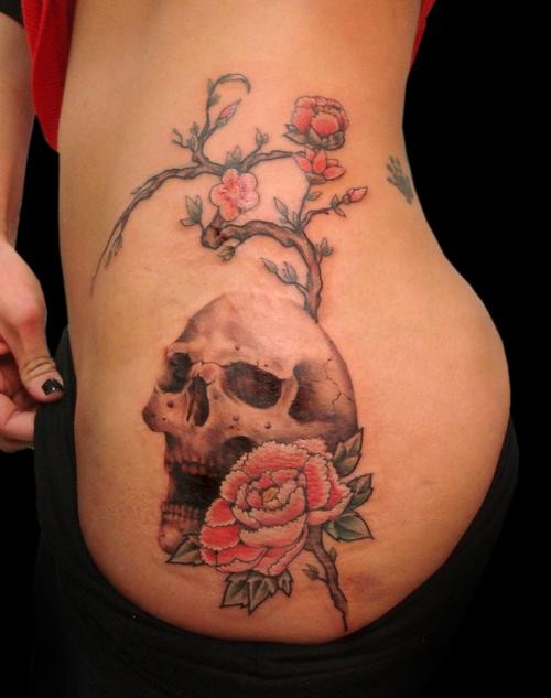 Fantastic looking colored side tattoo of human skull with blooming tree