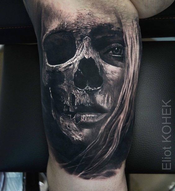 Fantastic painted biceps tattoo of woman face combined with skull