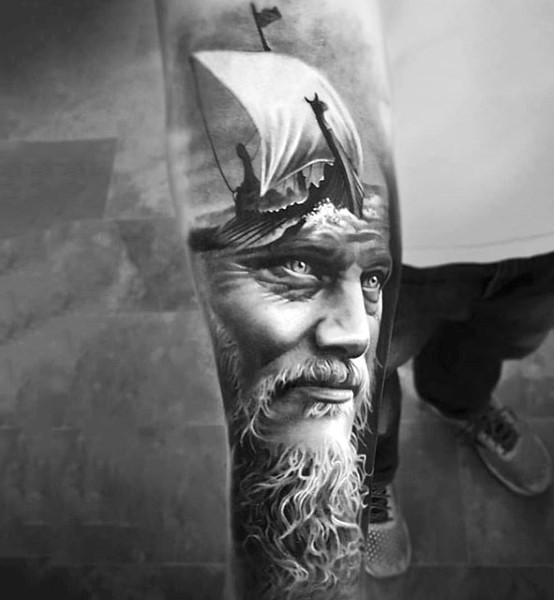Fantastic very realistic looking viking with ship tattoo on sleeve