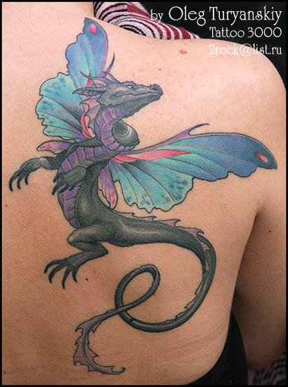 Fantasy like colored shoulder tattoo of dragon with fairy wings
