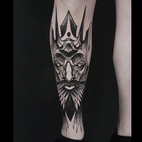 Fantasy style black ink painted by Michele Zingales leg tattoo of demonic mask