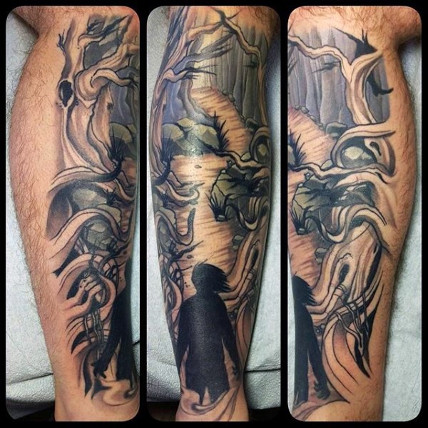 Fantasy style colored leg tattoo of interesting looking dark forest with human silhouette