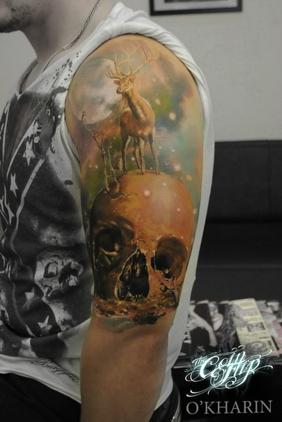 Fantasy style colored shoulder tattoo of human skull with deer