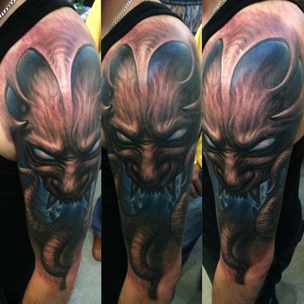 Fantasy style colored shoulder tattoo of demonic face