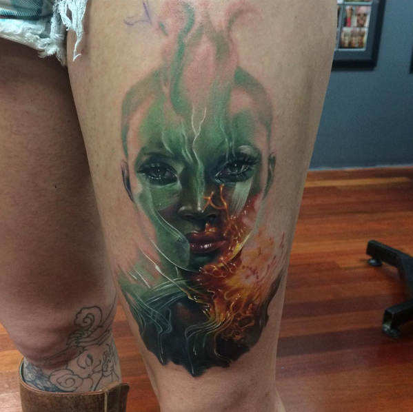 Fantasy style colored thigh tattoo of incredible woman with flames