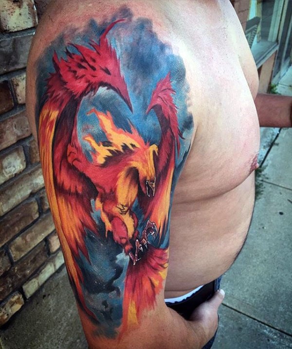 Fantasy style large creative colored upper arm tattoo of phoenix bird