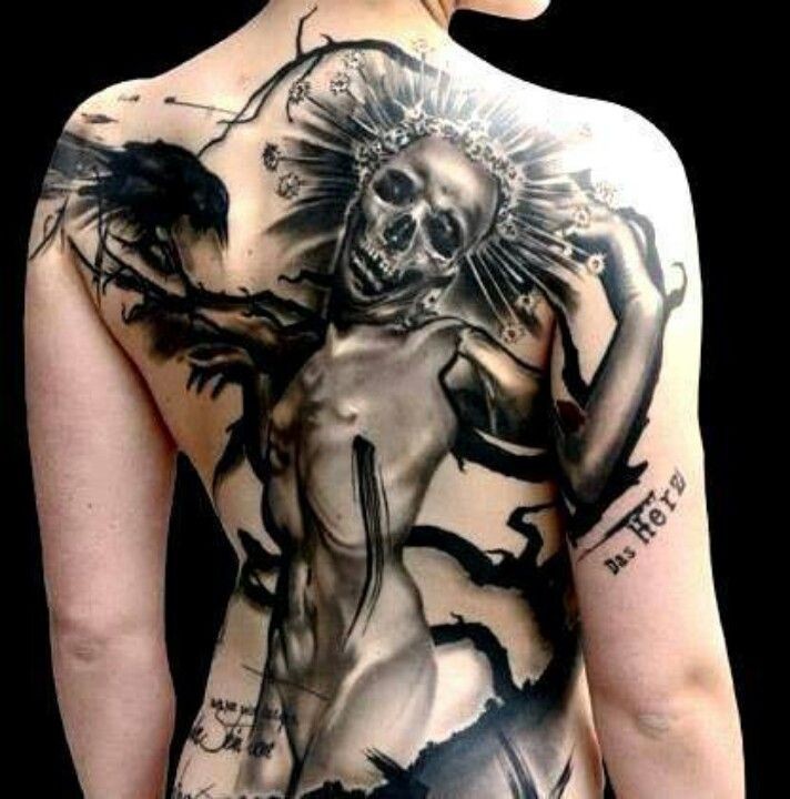 Fantasy style large whole back tattoo of mystical creature with lettering