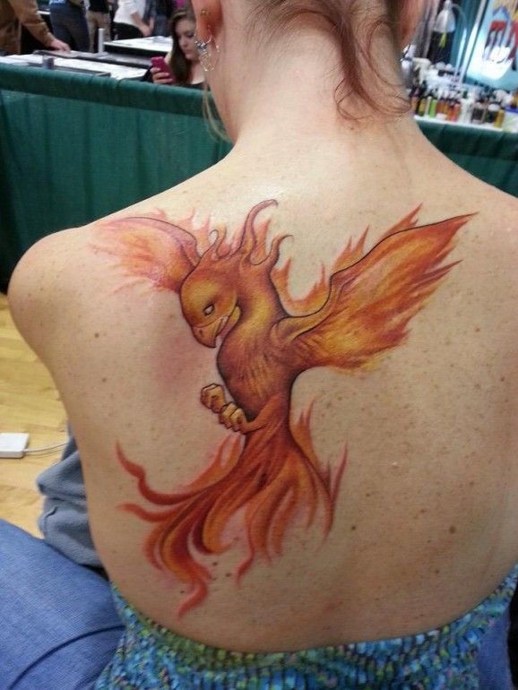 Fiery phoenix tattoo on back for women by sarah miller