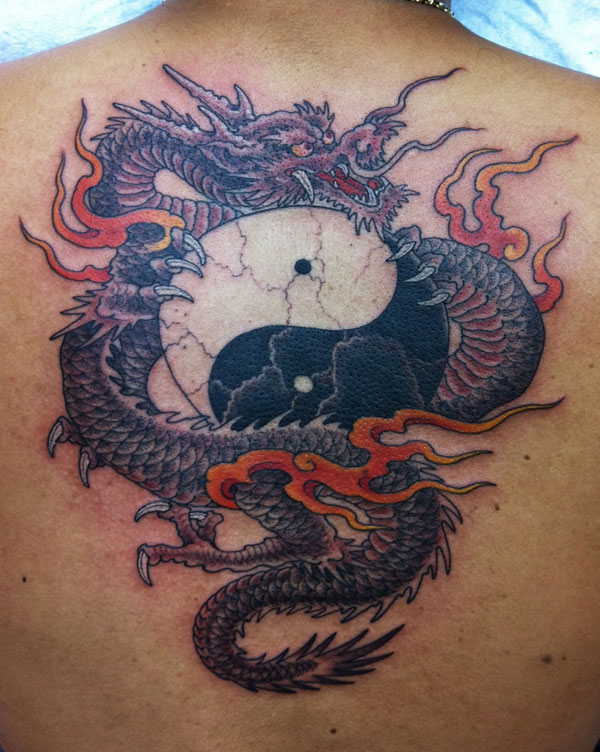 Flaming dragon yin yang tattoo on back
