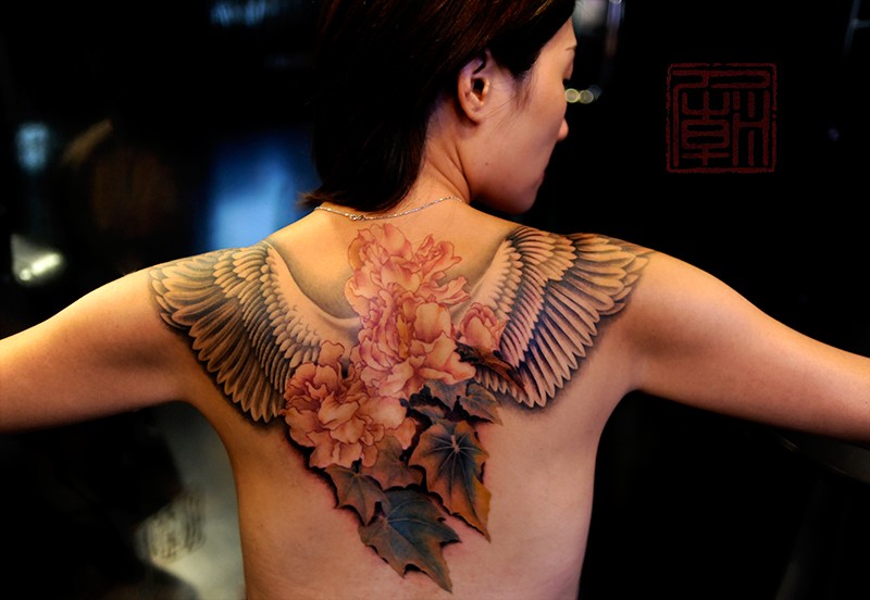 Flowers and wings tattoo on back for women