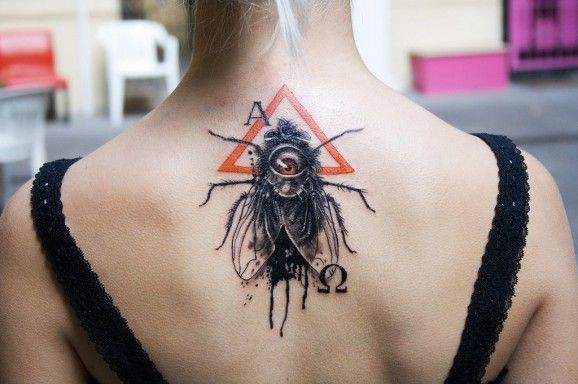 Fly and symbols tattoo on back