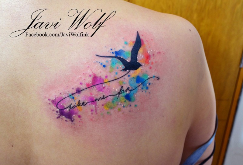 Flying black bird with lettering and colored paint drips in watercolor style shoulder blade tattoo by Javi Wolf