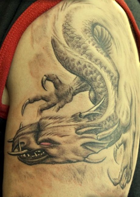 Flying dragon tattoo on shoulder