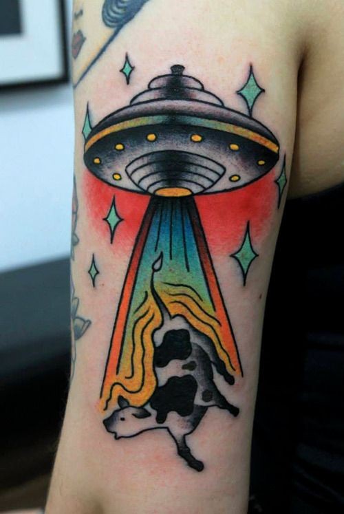 Flying ufo and cow tattoo on arm