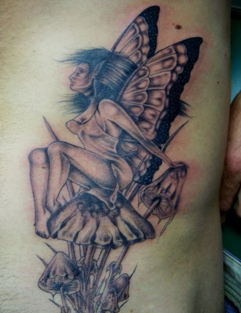 Forest fairy sitting on a mushroom tattoo