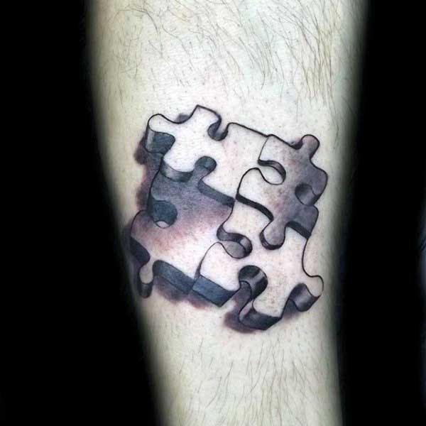 Four puzzle pieces volume tattoo on calf in 3D style