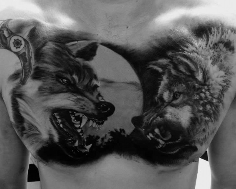 Full moon and two enraged wolf tattoo on chest by matt jordan