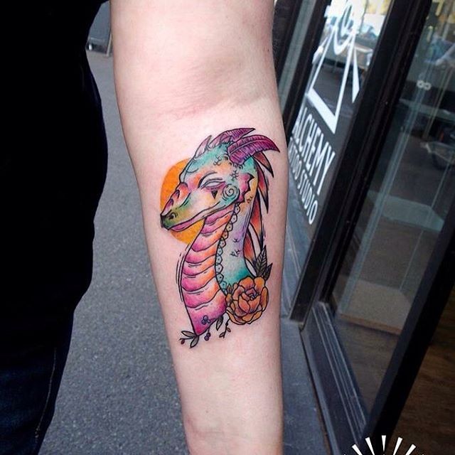 Funny bright colored dragon and sun forearm tattoo with flower