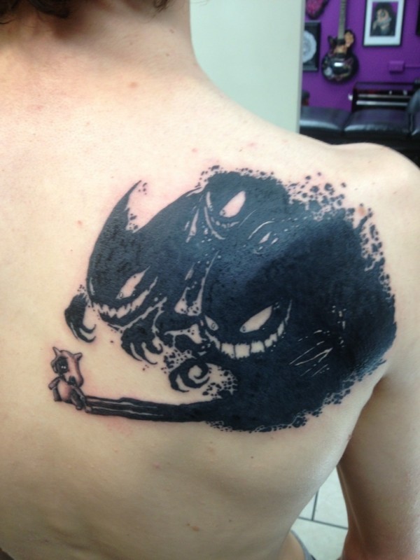 Funny cartoon like black ink on back tattoo of tiny cow with monster shadows