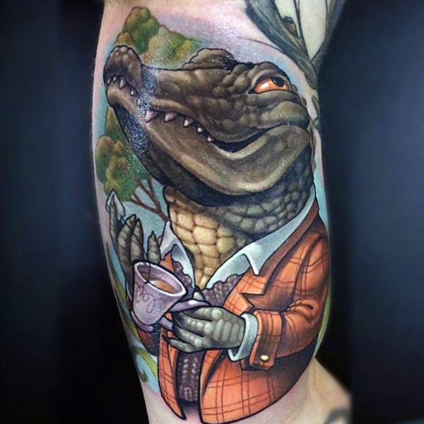 Funny cartoon like colored alligator in suit and white tea cup tattoo on arm