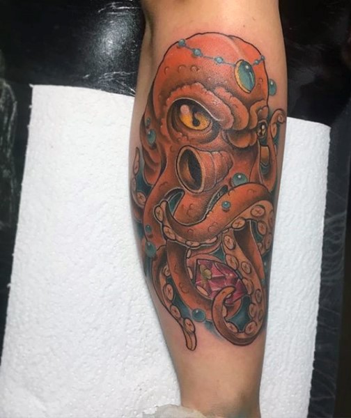 Funny cartoon like colored angry octopus tattoo on arm