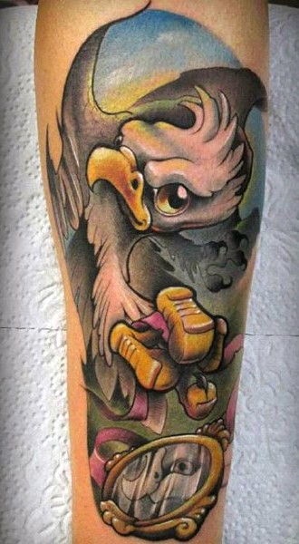 Funny cartoon like colored eagle with pink ribbon tattoo on leg